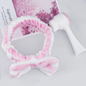 Pink striped bow headband and silicone facial cleansing brush set for daily skincare