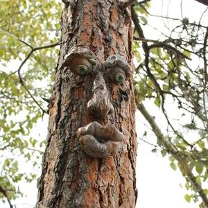 Outdoor glowing tree face resin decor with green eyes and realistic bark texture