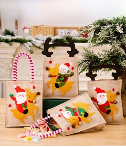 Detailed view of Christmas burlap gift bags featuring Santa and Snowman felt appliques