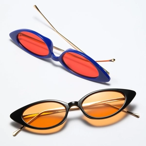 Close-up of retro narrow cat-eye sunglasses with blue and black frames and metal temples