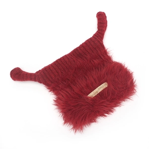 Detail of dark red knitted hat with long horn-shaped ears and fluffy faux fur trim