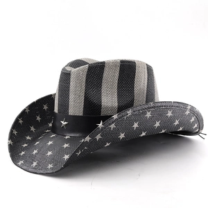 Detailed view of western straw hat with USA flag stars and leather strap with metal studs