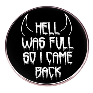 Black round brooch with Hell Was Full So I Came Back slogan and devil horns design