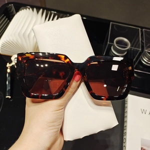 Detail of tortoise shell square oversized sunglasses with chunky frames and texture