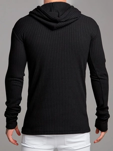 Macro shot of vertical ribbed texture and knit fabric on a slim fit black hoodie
