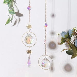 Close-up of golden sun catchers with AB colorful crystal prisms and metal chains