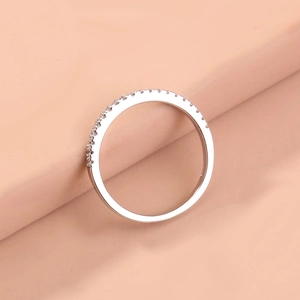 Detailed view of brass ring featuring micro-pave white cubic zirconia stones in a minimalist style