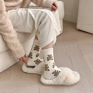 Cozy white coral fleece socks with cute brown bear patterns and matching plush slippers