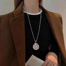 Silver titanium steel square snake chain with a Roman numeral pendant on a male model
