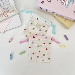 Minimalist cotton drawstring pouch set with colorful polka dots on a white background