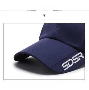 Detail of dark blue baseball cap featuring white SDSR embroidery and waffle mesh texture