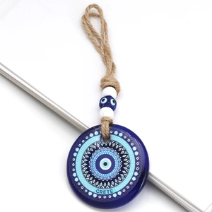 Blue glass evil eye pendant with Crete lettering and decorative hanging jute rope