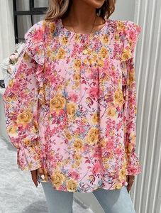Detailed view of pink floral blouse featuring yellow roses and ruffled chest design