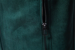 Macro shot of dark green suede fabric texture and premium metal zipper detail on jacket