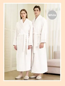 Close-up of white plush bathrobe featuring textured waffle trim on the collar and cuffs