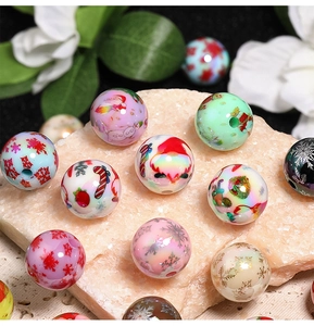 Macro shot of colorful Christmas beads with Santa and snowflake patterns for DIY jewelry making