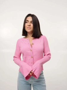 Detail of pink ribbed knit cardigan featuring golden buttons and flared slit sleeves
