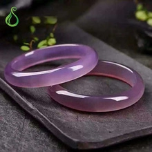 Close-up of a pair of lavender chalcedony agate bangles with polished oily luster