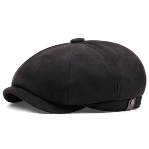 Detailed view of black newsboy cap with brushed texture and vintage metal side buckle