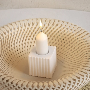 Close-up of white square striped candle holder with vertical grooves for DIY decor