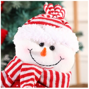 Close-up of plush Christmas snowman doll with red and white stripes and carrot nose detail