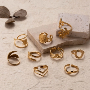 Set of 9 gold adjustable stainless steel rings with star, snake, and leaf designs