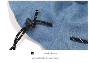 Close-up of blue denim bucket hat featuring an adjustable black drawstring with plastic toggle