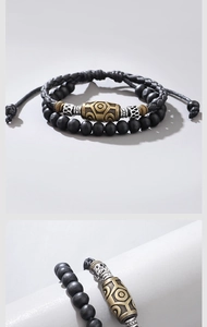 Detailed close-up of woven rope bracelet featuring retro dZi beads and skull charms