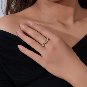 Detailed view of an S925 silver gold-plated ring set with rainbow cubic zirconia stones