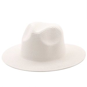 Detail of white woven straw Panama hat featuring a classic indented crown and smooth brim