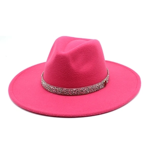 Close-up of rose red wool felt fedora with sparkling rhinestone band and gold logo detail