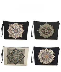Detailed pattern view of four mandala style makeup bags with zippers and wrist straps