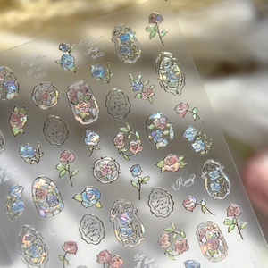 Macro shot of laser holographic rose nail art stickers with iridescent floral patterns