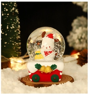 Detailed view of Christmas crystal ball featuring a cute dog in a red sleigh base