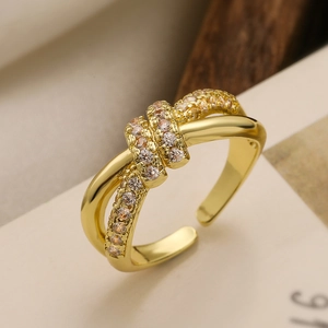 Detail of 18K gold-plated knotted ring with micro-set cubic zirconia and polished finish