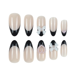 French tip almond press-on nails with 3D bows and heart pearls in nude and black