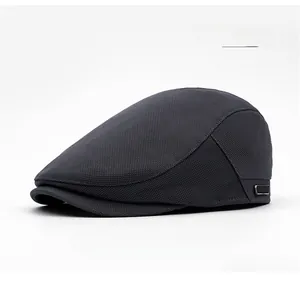Detailed close-up of dark grey mesh fabric and metal side buckle on newsboy cap