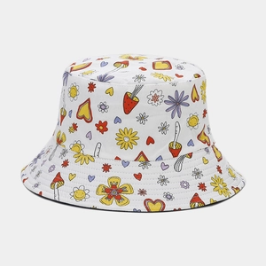 Close-up of white sun hat featuring colorful hand-drawn mushroom and flower patterns