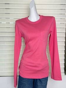 Detailed texture of hot pink long sleeve cotton T-shirt with chest pocket detail