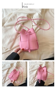 Detail shots of pink woven mini bucket bag with drawstring closure and slim shoulder strap