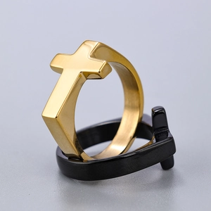 Close-up of minimalist gold and black stainless steel cross rings stacked together