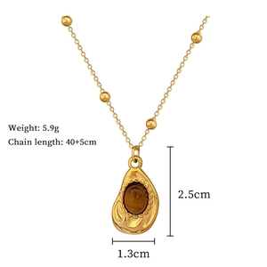 Detail view of a gold water-drop pendant with amber stone, measuring 2.5cm by 1.3cm