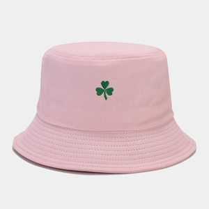 Détail de la broderie trèfle vert sur un chapeau bob en toile de coton rose