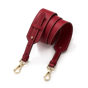 Adjustable red lychee pattern leather shoulder strap with gold hardware and white stitching