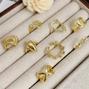 Set of 8 gold plated 18K rings and earrings featuring heart, infinity, and bow designs