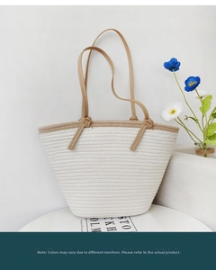Detailed weave of white cotton rope tote with contrasting brown leather shoulder straps