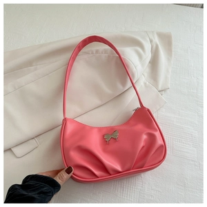 Close-up of pink pleated crescent bag with glossy texture and silver butterfly buckle