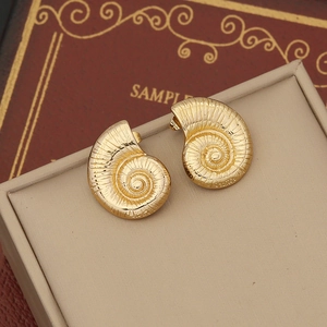 Gold geometric irregular earrings with nautilus shell spiral texture in vintage style