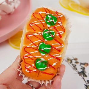Realistic high-rebound PU fruit jam cupcake squishy toy with green toppings in hand
