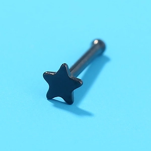 Macro view of a black star-shaped nose stud piercing made of durable stainless steel